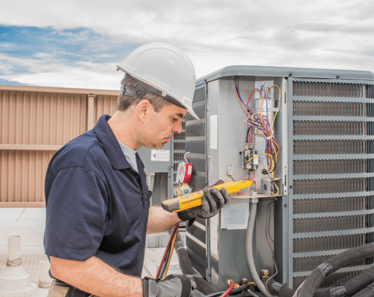 HVAC technician inspecting air conditioner