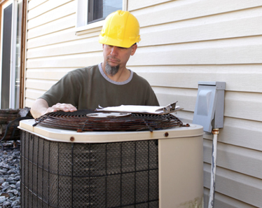 technician installing air conditioner