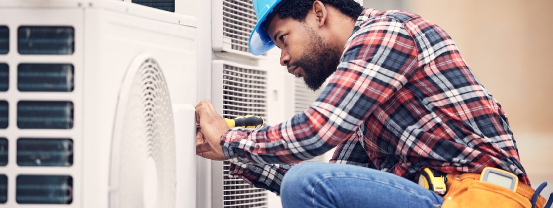 A technician repairing a Heat Pump